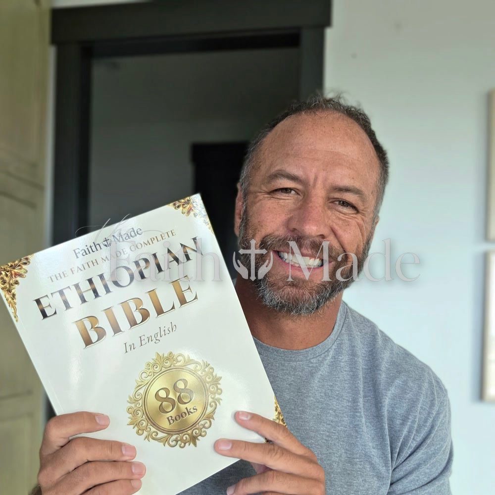 A reader holding The Faith Made Complete Ethiopian Bible